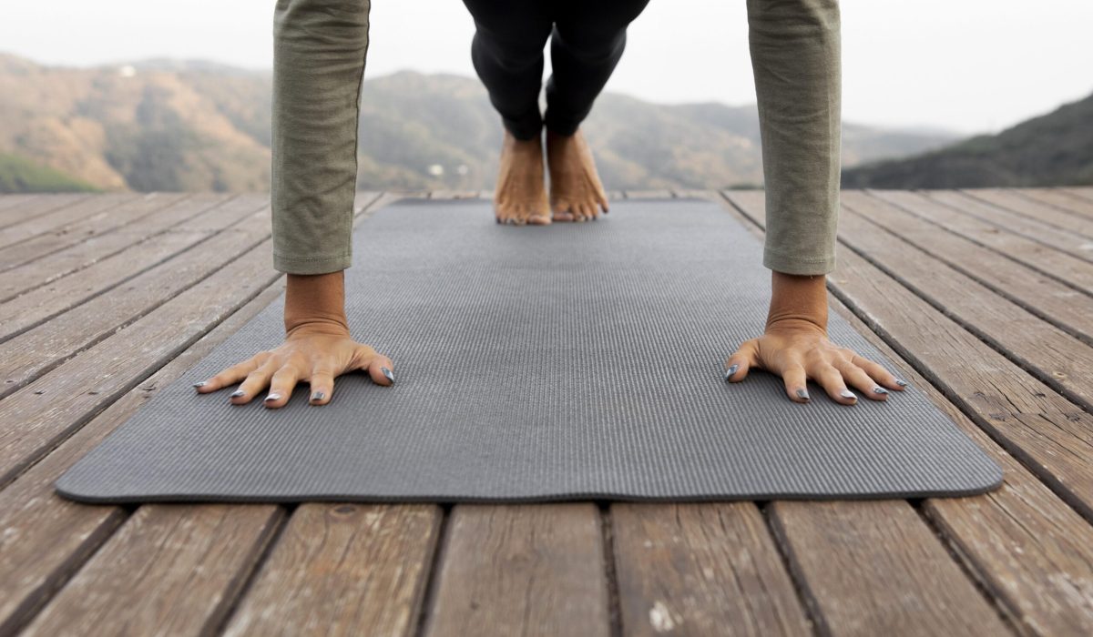 front-view-woman-doing-yoga-outdoors-mat